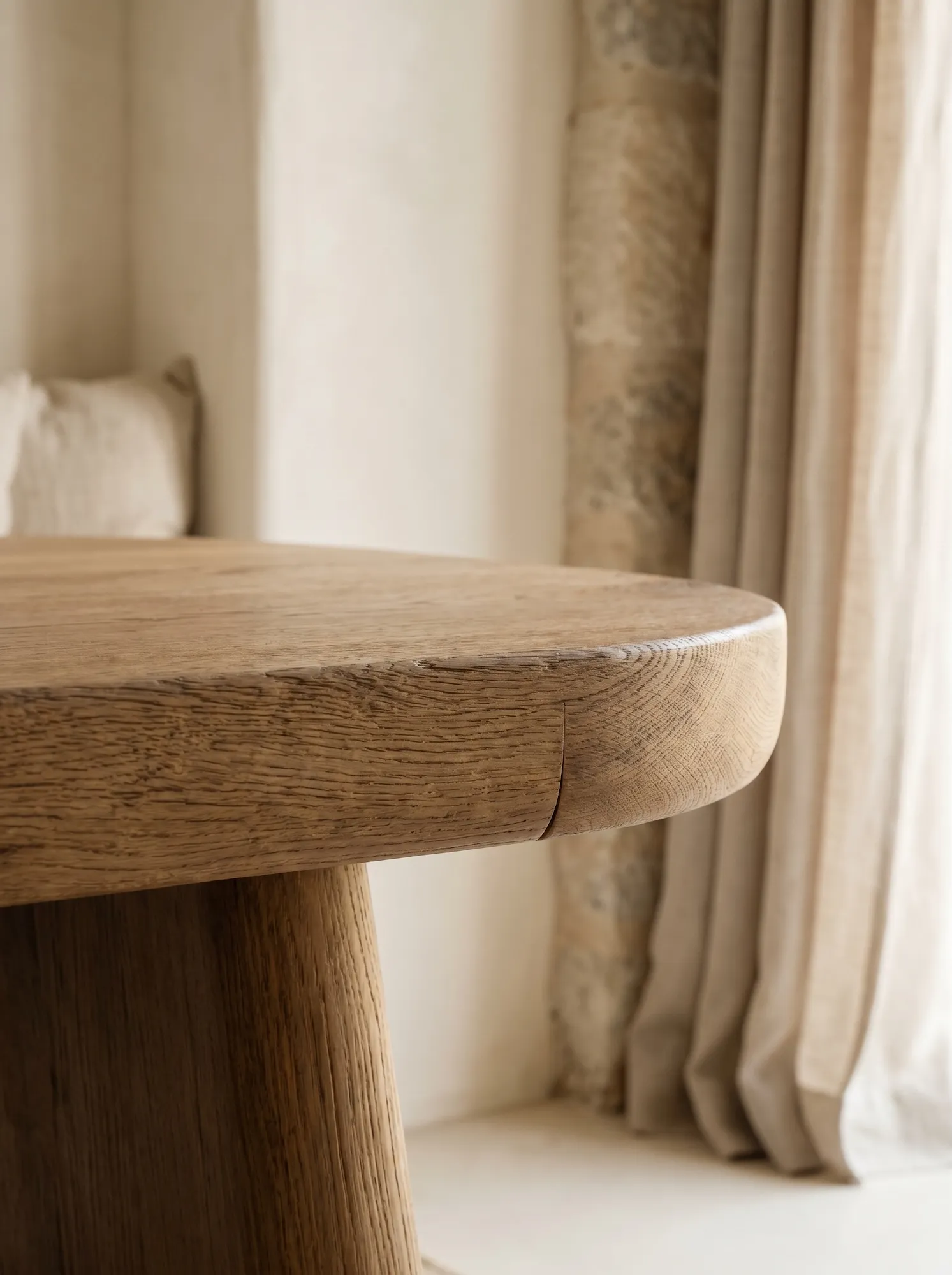 Close-up of hand-finished oak edge with visible grain and soft shadow